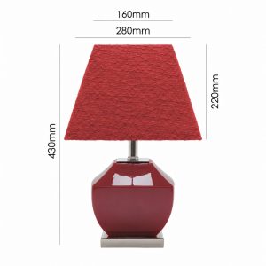 Chai red ceramic table lamp with a textured red shade styled on a living room side table