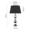 Modern table lamp with tall sculptural base and black shade