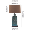Modern blue ceramic table lamp with embossed floral motif for elegant interiors