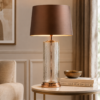 LLT Masaki Table Lamp styled on bedside console in grand master suite interior with warm gold and chocolate luxury tones