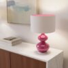Pink glass table lamp with white drum shade