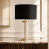 LLT Empire Black Table Lamp styled on bedside table in modern hotel-style bedroom interior with black and brass accent tones