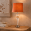 The LLT Poppy Table Lamp brings warmth and softness to modern interiors. Its chrome base adds a clean, reflective accent. At the same time, the peach glass body introduces gentle colour and visual depth. Height: 600mm Width: 300mm Base: 115mm Shade: 300x300x220mm Colour/Material: Chrome/Peach Glass Base, Peach Round Tapered Shade