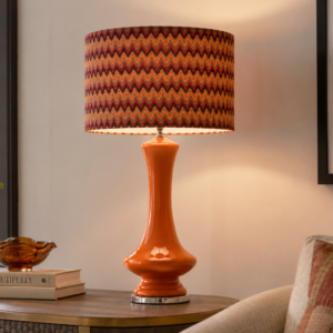 LLT Tanager Chevron Table Lamp styled as statement piece in contemporary living room interior with warm burnt orange tones